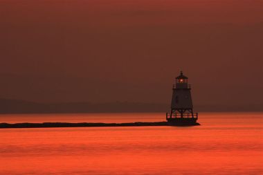 Light house in Lake Champlain at dusk, as seen from Burlington Vermont. Photo by Nagaraju.ramanna. Wikimedia Commons.