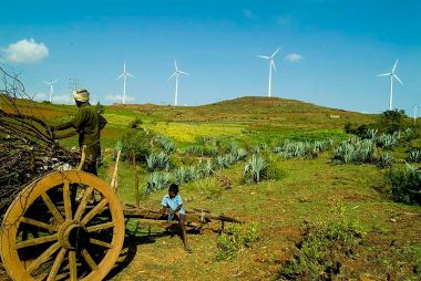 Field and wind turbines in India. Courtesy of Vestas. Creative Commons Attribution 2.0 Generic license. Wikimedia Commons.