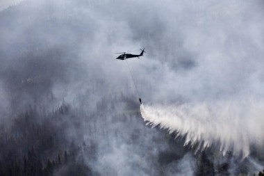 An Alaska Army National Guard helicopter drops water on the Stetson Creek Fire near Cooper Landing, Alaska, on June 17 2015. Photo by Sgt. Balinda O'Neal, US Army National Guard. 
