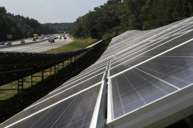Two solar farms alongside the Mass. Pike contain 2,100 panels each. Photo by Joanne Rathe/Globe Staff