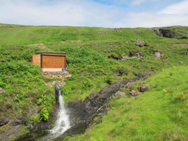 A small hydro turbine building in a Scottish wilderness.