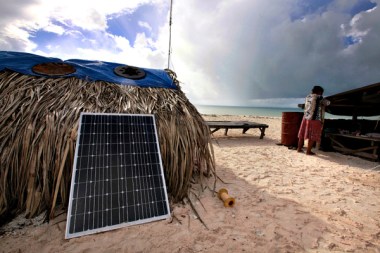 A woman checks the roof of her home as a storm approaches the central Pacific island nation of Kiribati, which consists of islands that stand just a few feet above sea level. David Gray/Reuters/File