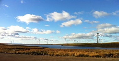 Whitelee's wind farm with Arran in the background. Photo by Bjmullan. CC BY-SA 3.0. Wikimedia Commons. 