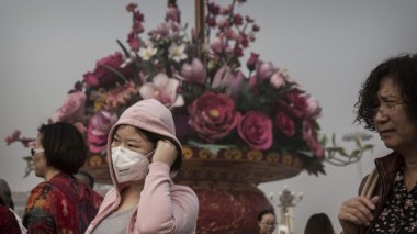 A woman in China wears a mask to counter pollution. Getty Images