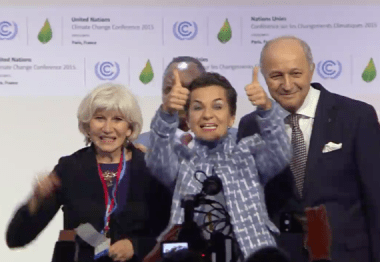 Laurence Tubiana, Christiana Figueres, and Laurent Fabius applaud the Paris Agreement