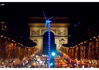 A power-generating wind turbine is seen on the Champs Elysees avenue with the Arc de Triomphe in background as part of COP21. - AP