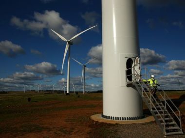 A Vestas service technician walks up the stairs to the door at the base of a wind turbine at the Taralga Wind Farm. (Photo: Mark Kolbe, Getty Images)