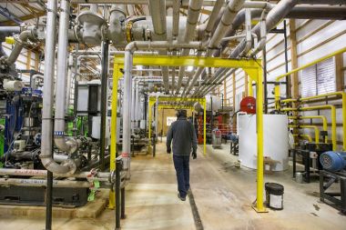 Andrew Sloat, at Green Cow Power in Goshen, walks through the engine room. SBT Photo/Becky Malewitz