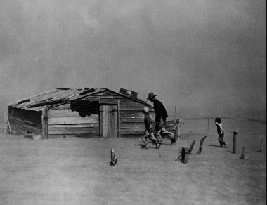 Farmer and sons walking in the face of a dust storm. Cimarron County, Oklahoma. Photo by Rothstein, Arthur, 1915-1985. US Farm Security 