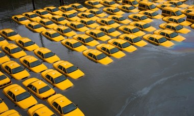 A parking lot full of yellow cabs flooded by Superstorm Sandy in Hoboken. Photograph: Charles Sykes/AP