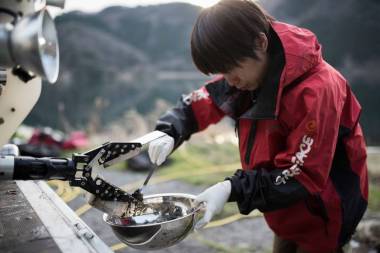 A Greenpeace Japan member removes sediment samples from a remotely operated grabber at Lake Biwa. | © Christian Åslund / Greenpeace