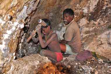 Seven-year-old Karulal works with his father in a mica mine. Photograph: Peter Bengtsen