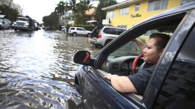 Sandy Garcia sits in her vehicle on a flooded street in Fort Lauderdale. (Joe Raedle / Getty Images)