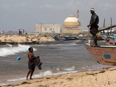 A fisherman stands on his boat on a beach  near Kudankulam nuclear plant. (Photo: Reuters)