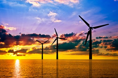 Silhouette of wind power stations over the sea at sunset (Photo: Bureau of Ocean Energy Management)