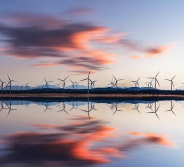 Wind turbines reflected on the water