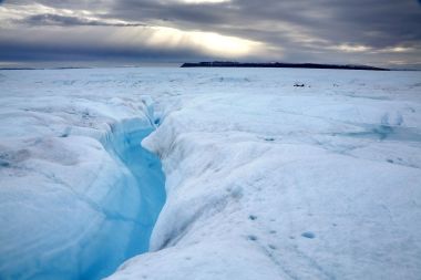 A deep gully with rushing water feeds into a river on Petermann Glacier. (MUST CREDIT: Washington Post photo by Whitney Shefte)