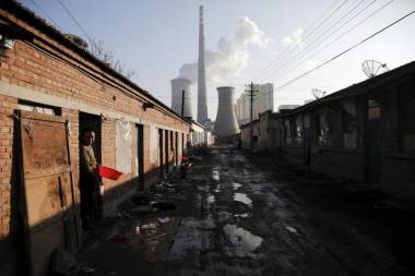 A migrant worker steps out of his accommodation in an area next to a coal power plant in Beijing on a smog-free day. (Reuters / Damir Sagolj)